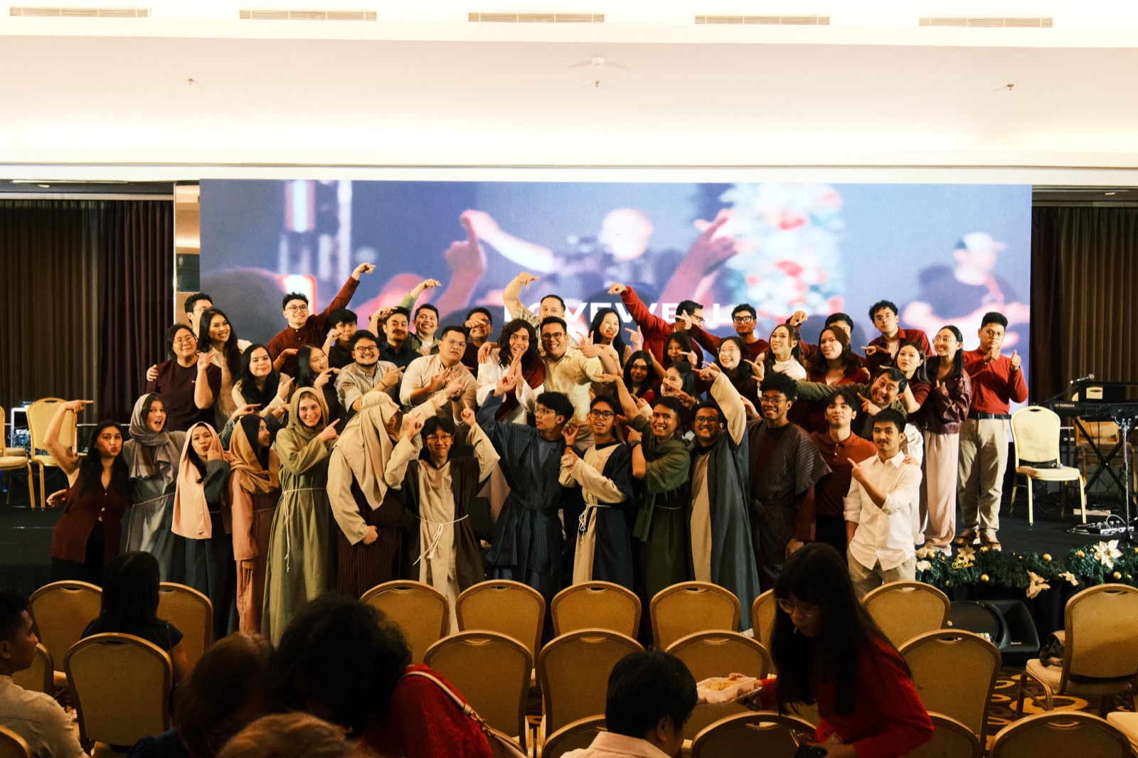 The Crosswalk family posing together on stage after a Christmas service